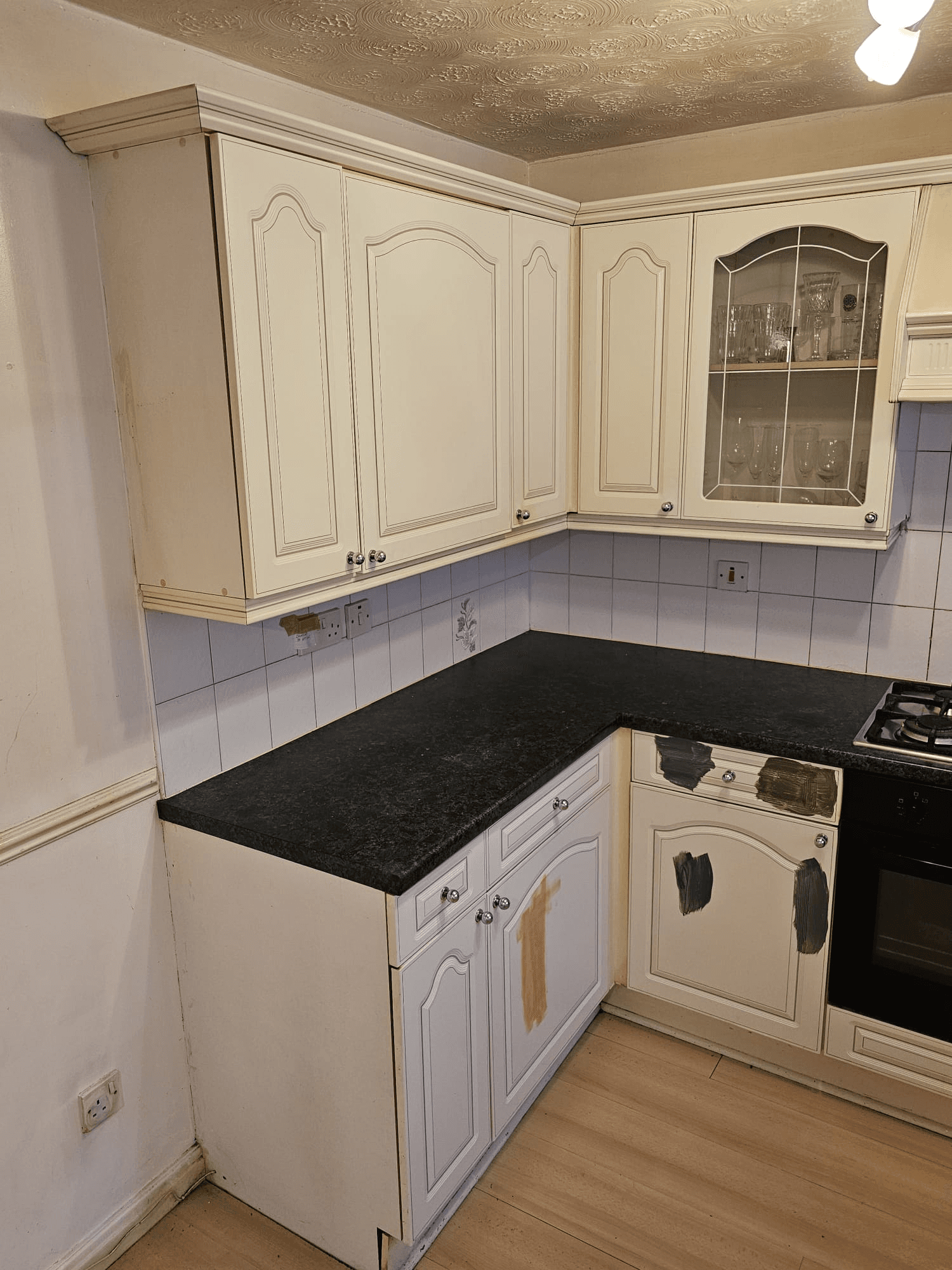 Kitchen before respray Sheffield — cream corner cabinets with black worktop
