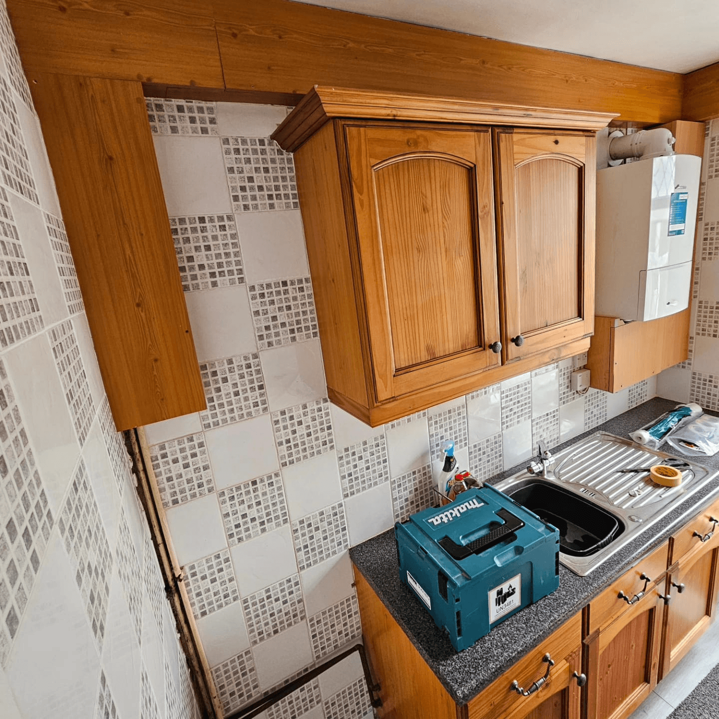Kitchen before respray Sheffield — oak galley wall units overhead view