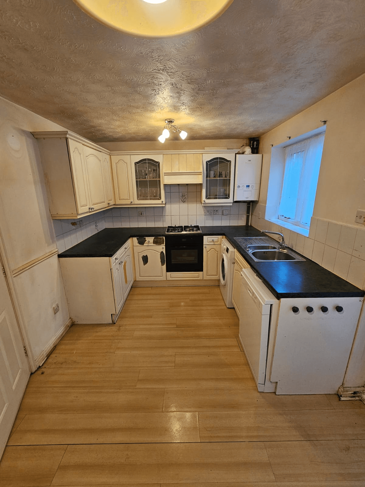 Kitchen respray Sheffield — completed cream U-shape kitchen with black worktops