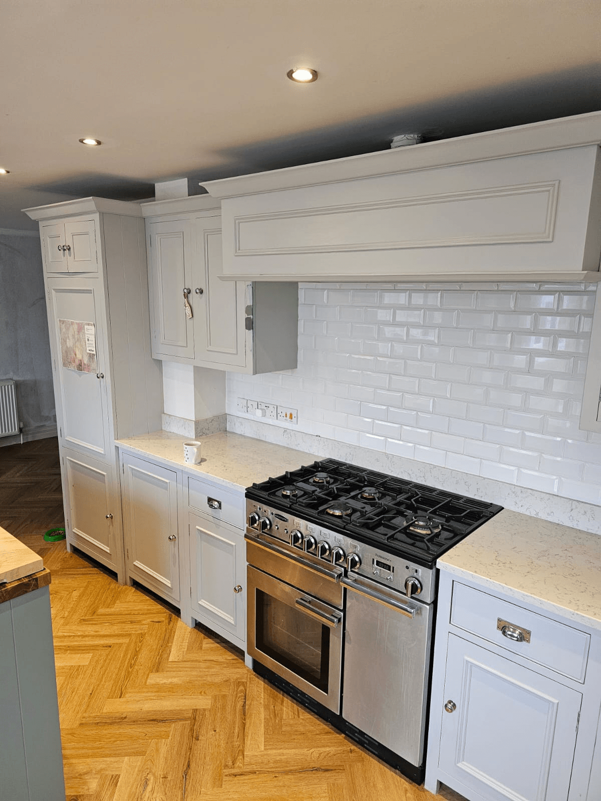Kitchen respray Sheffield — white wall units with range cooker and metro tile splashback