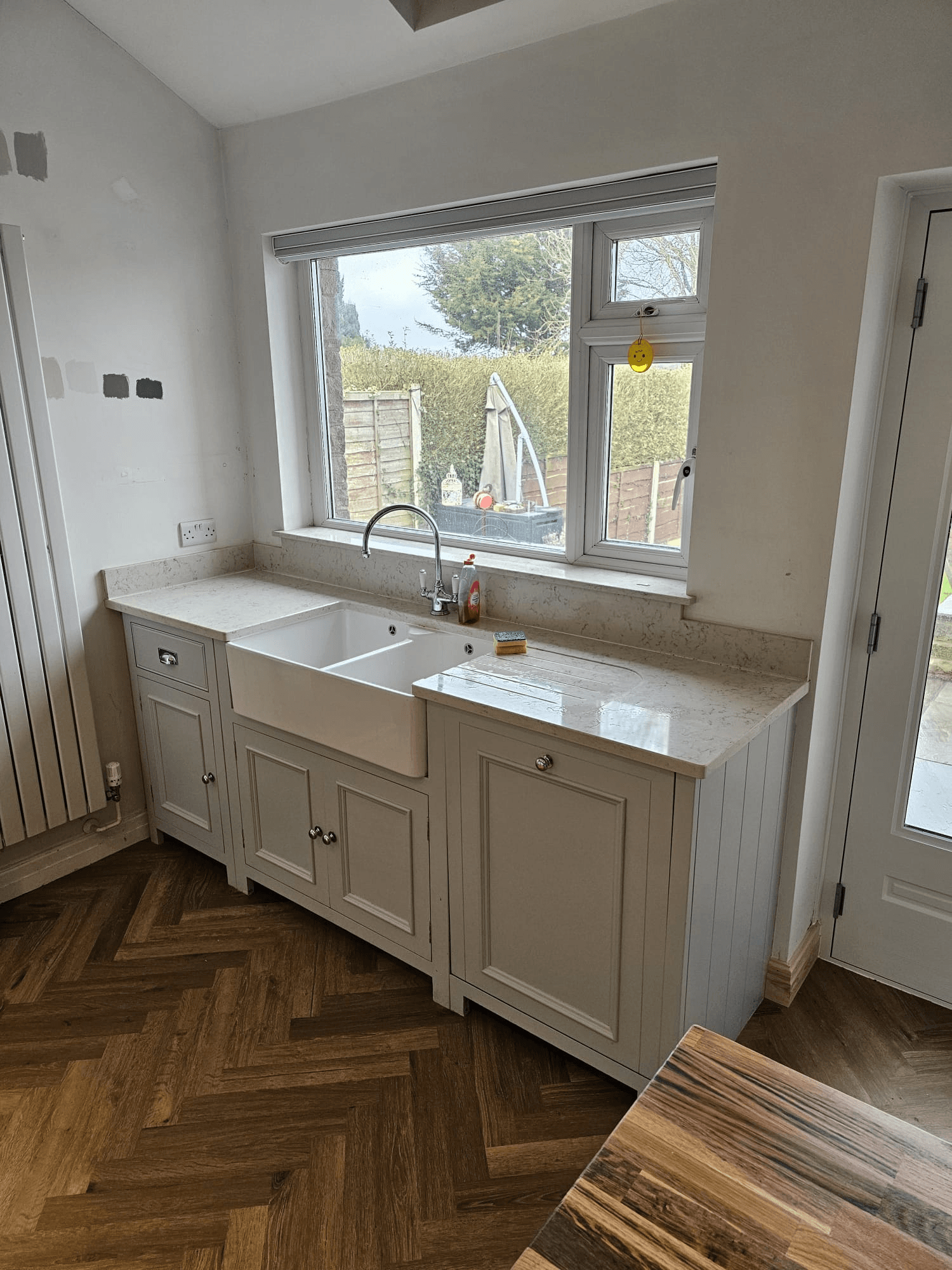 Kitchen respray Sheffield — white base units with belfast sink and herringbone floor
