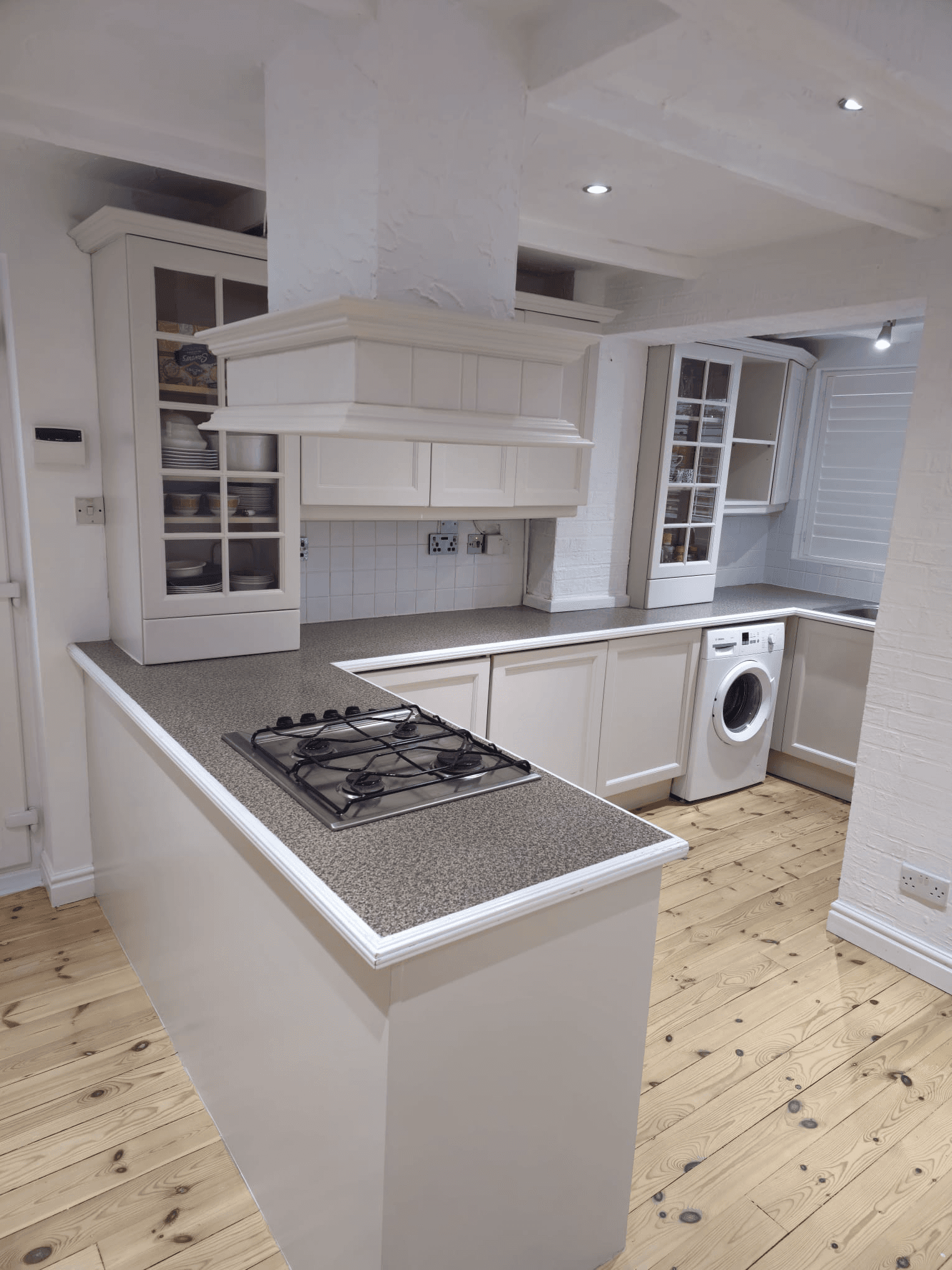 Kitchen respray Sheffield — white kitchen full view with granite worktop