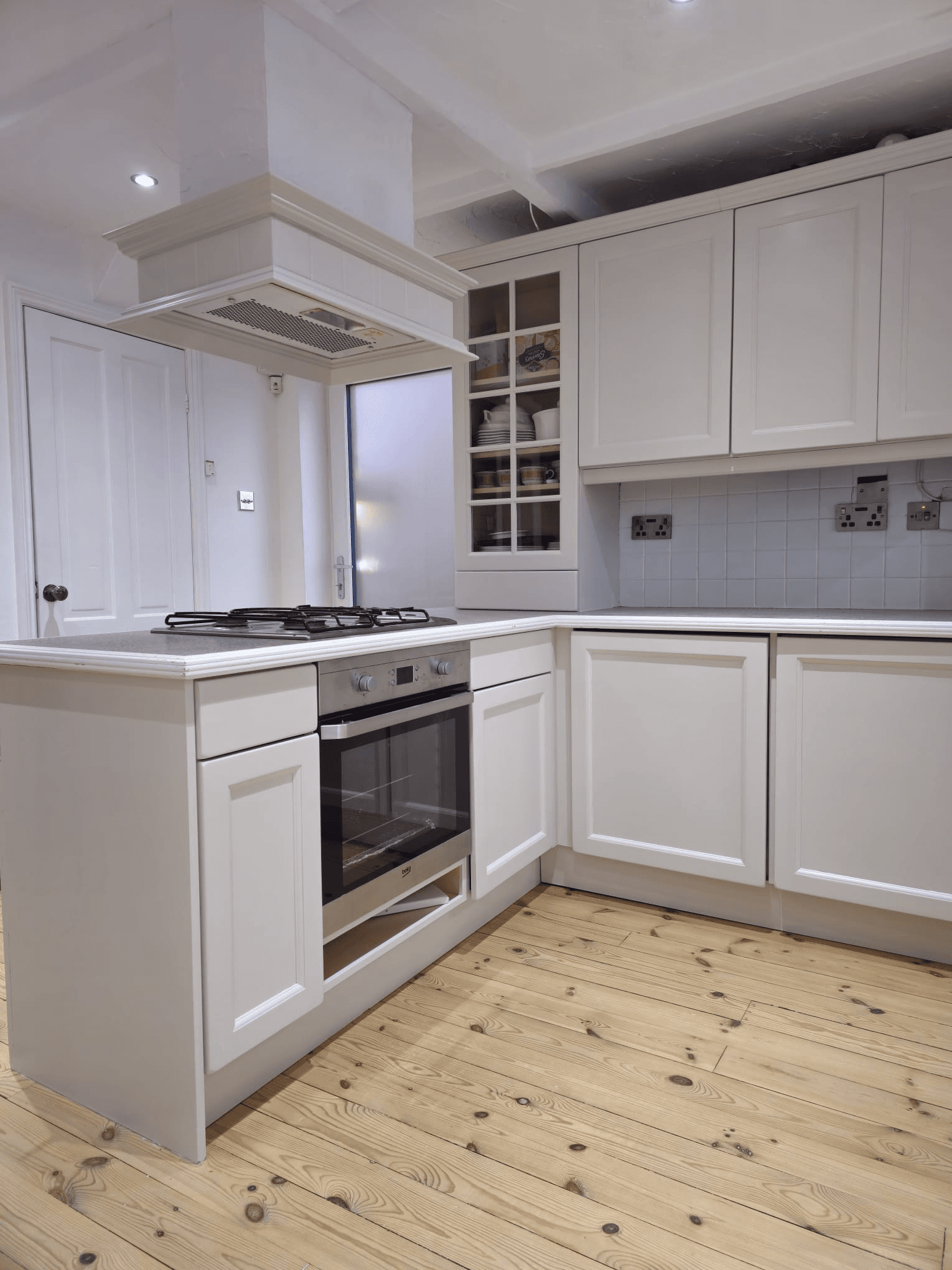 Kitchen respray Sheffield — white base units with oven